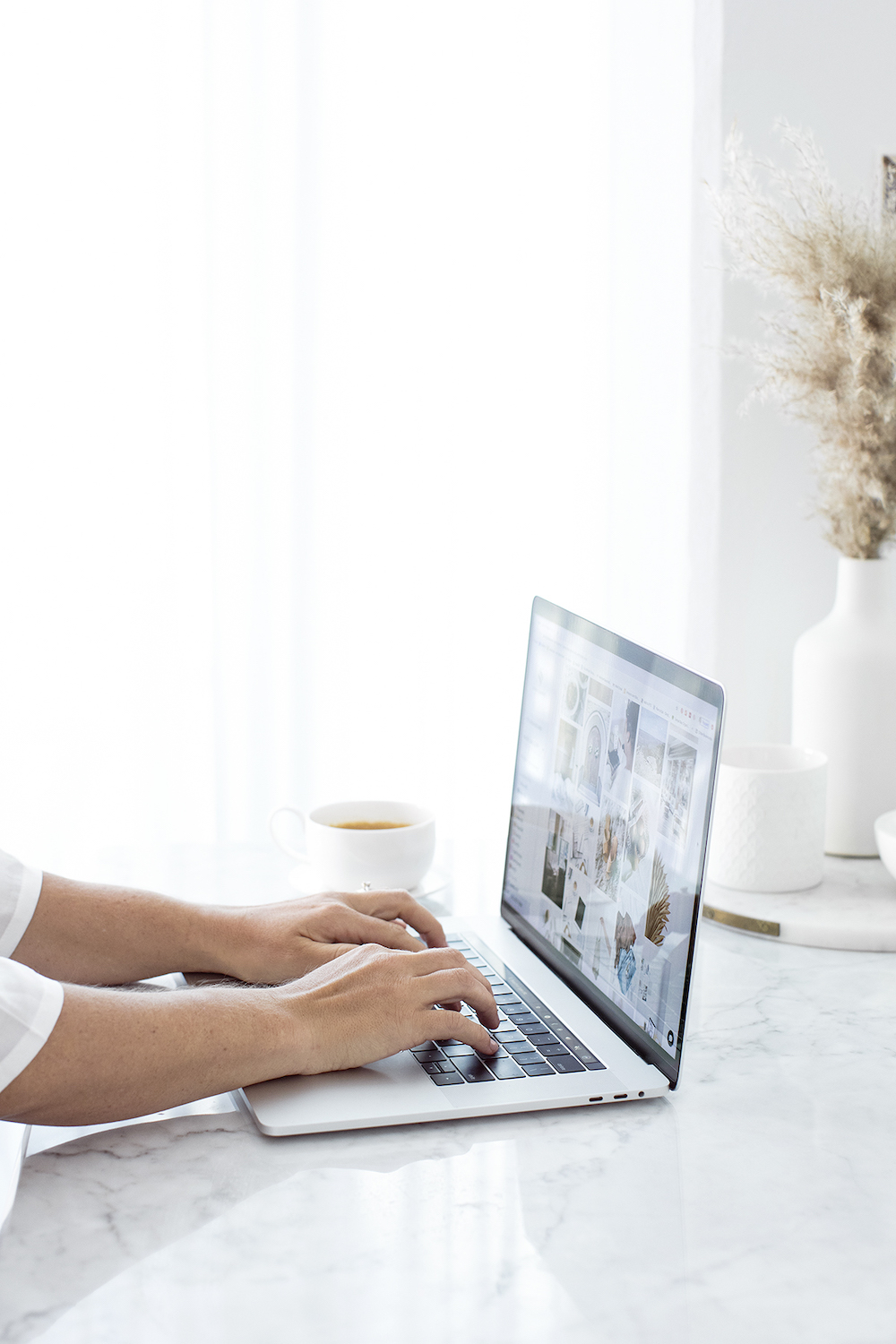 Woman standing behind her desk, organizing papers that outline the anatomy of a high-converting email.